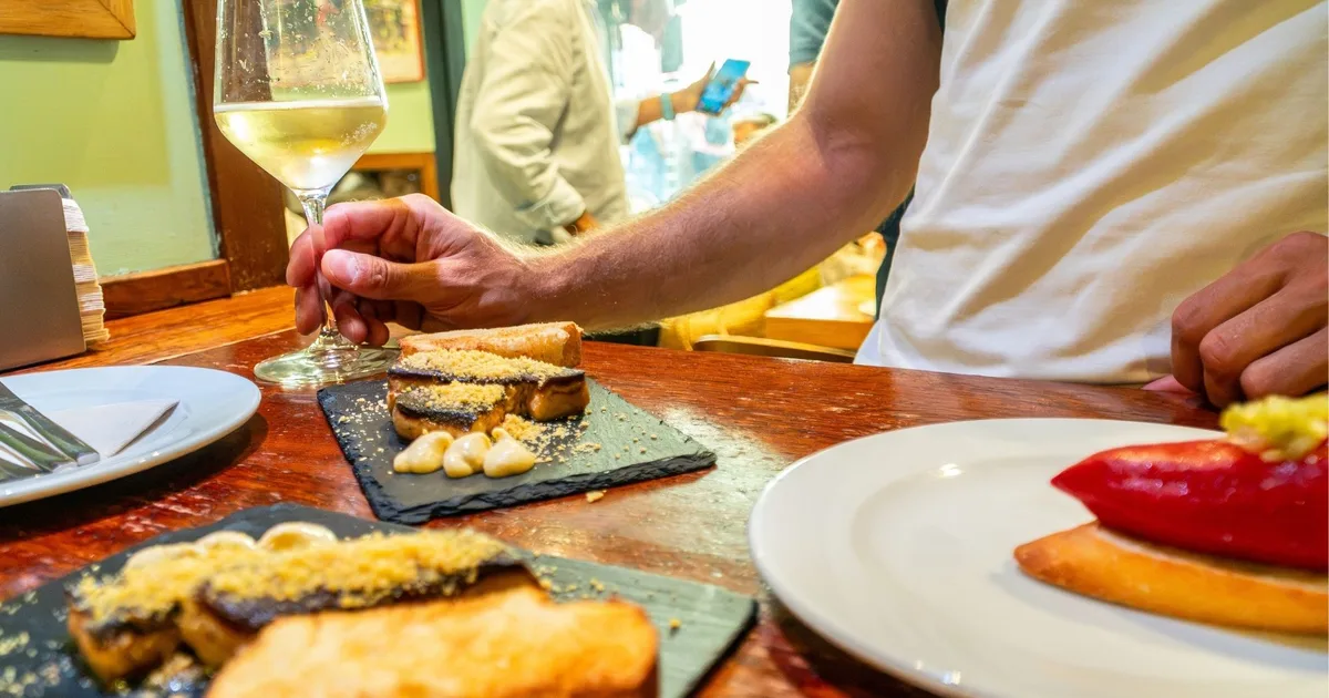 Pintxos and drinks on a wooden counter in a San Sebastián bar