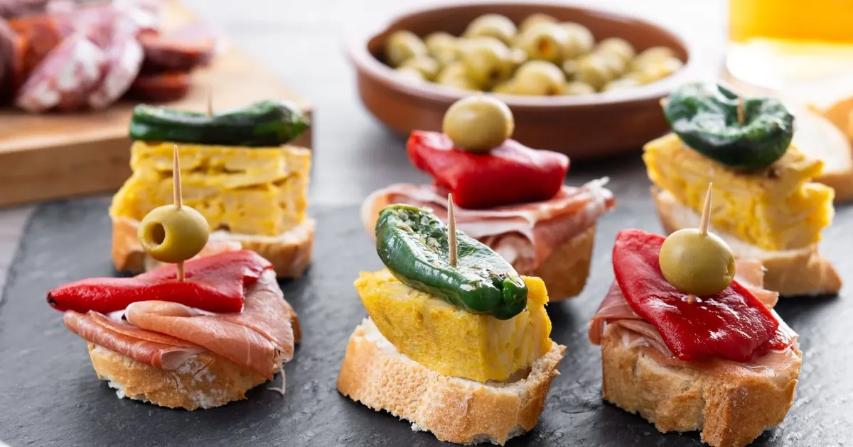 Pintxos with tortilla, peppers and olives on a bar counter in San Sebastián