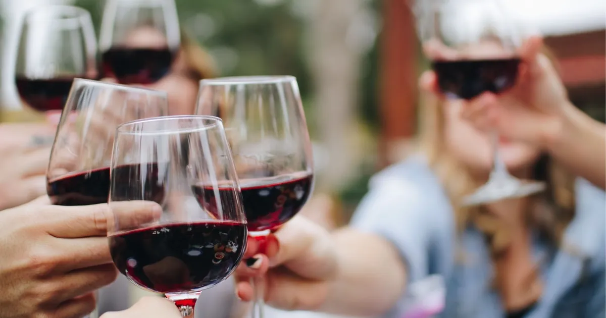 Glasses of red wine raised at a bar in San Sebastián