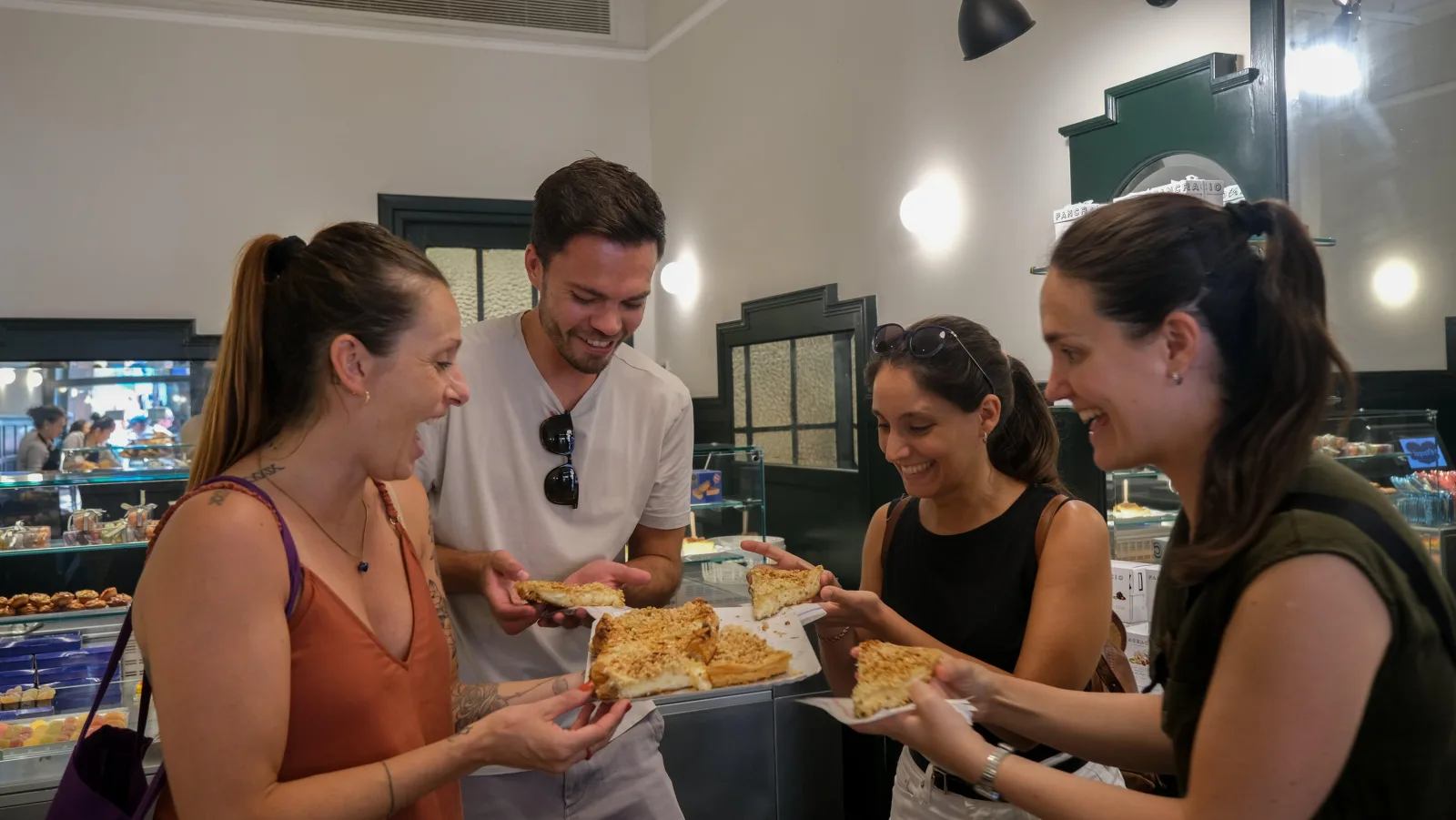 Guests sharing plates of tortilla inside a neighbourhood bar
