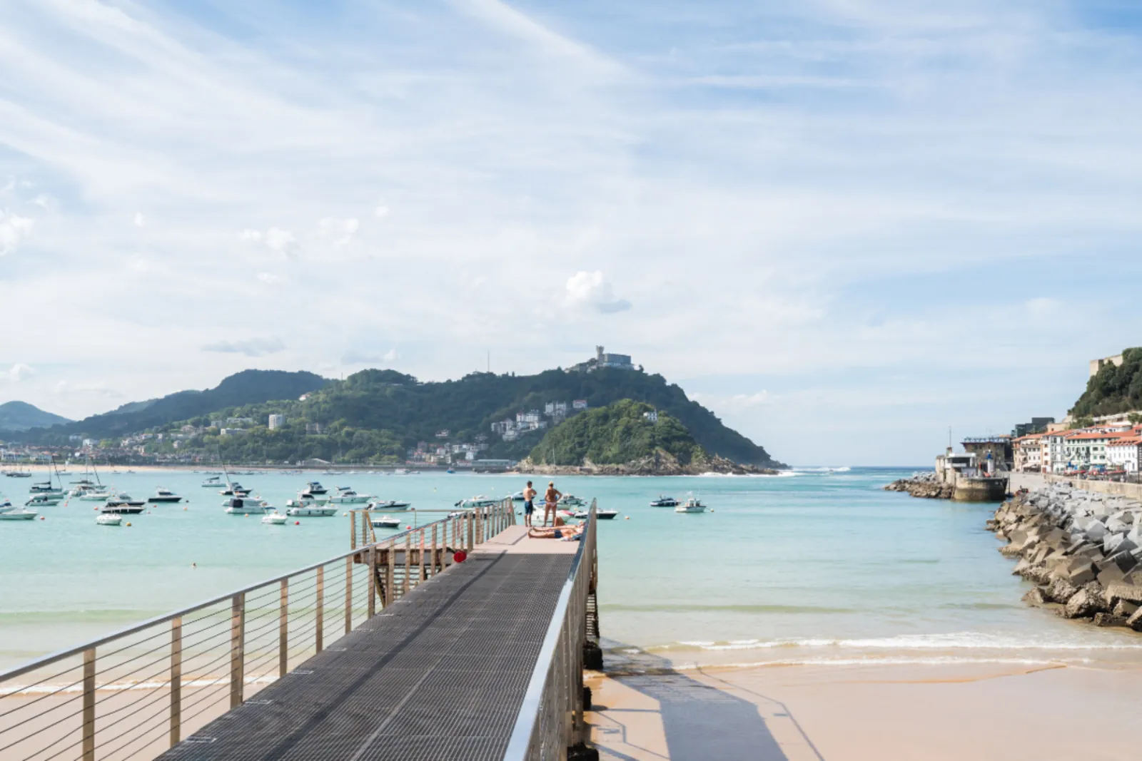 La Concha bay from the pier, with moored boats and Monte Igueldo across the water