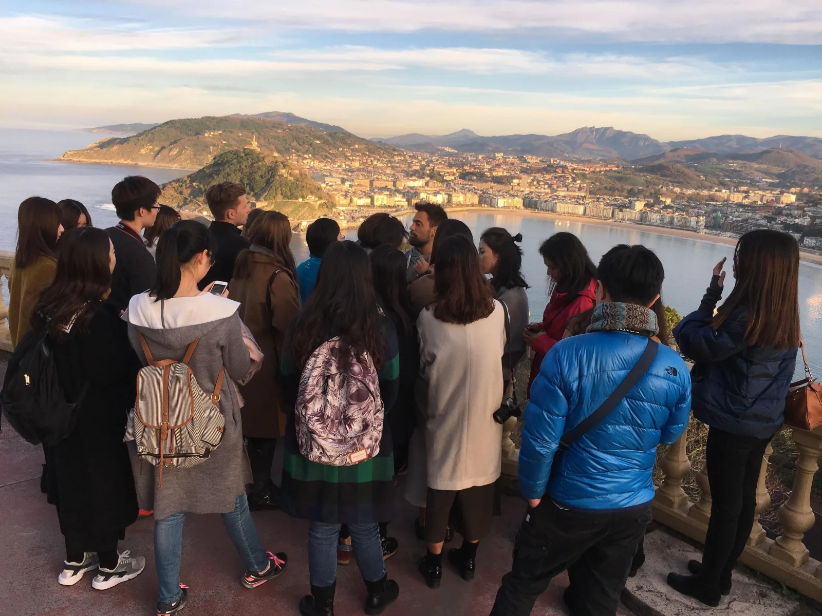 Group of visitors looking out over La Concha bay and the city from the Monte Igueldo terrace