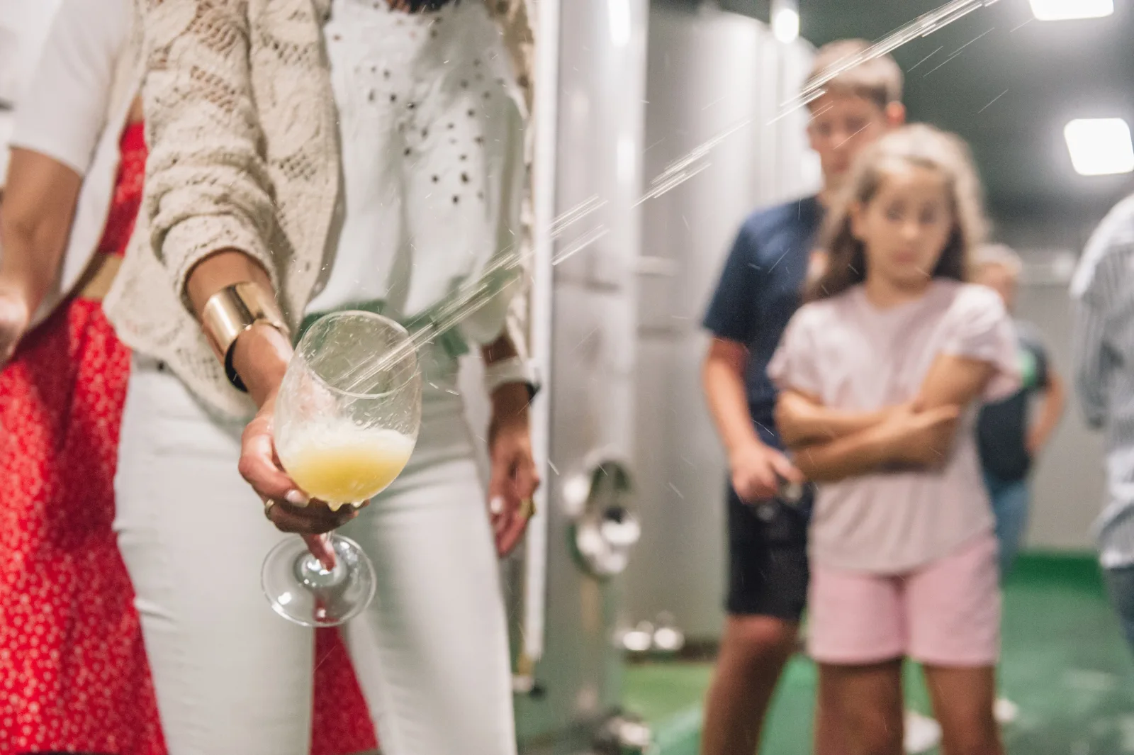 Guest catching cider straight from the barrel in the fermentation hall